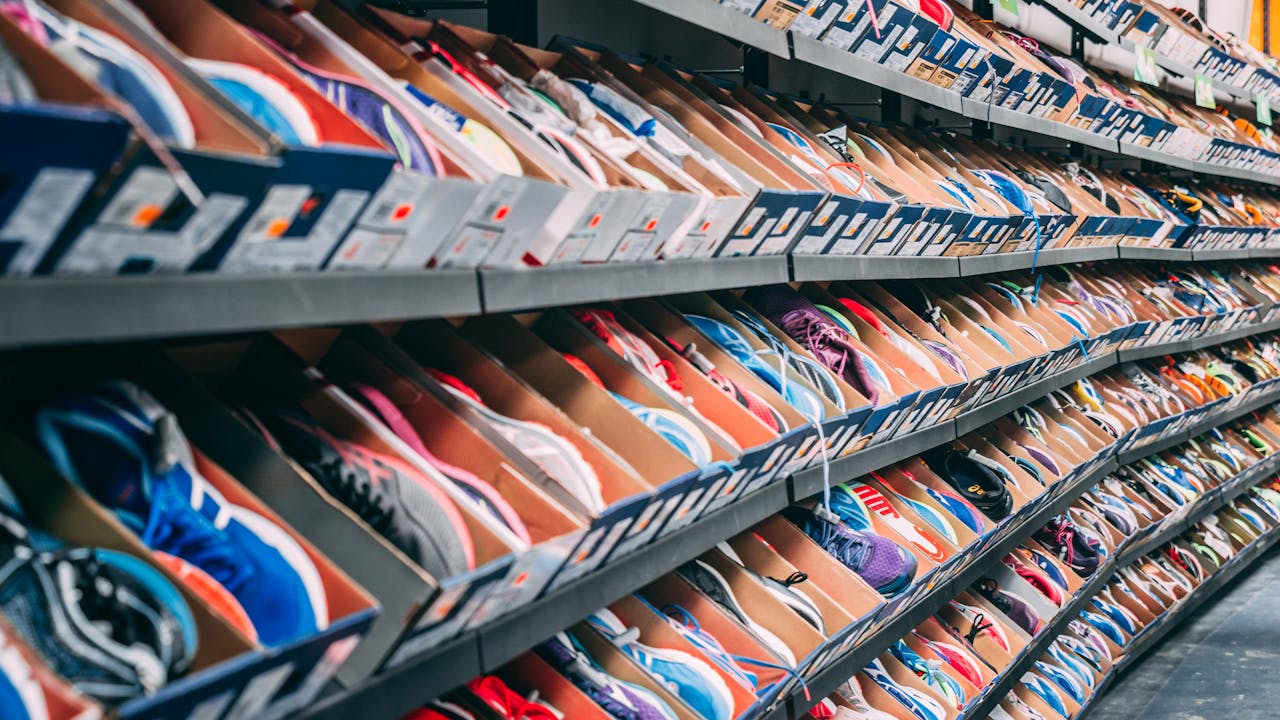 A vibrant display of various sneakers on shelves in a shoe store, showcasing styles and options.